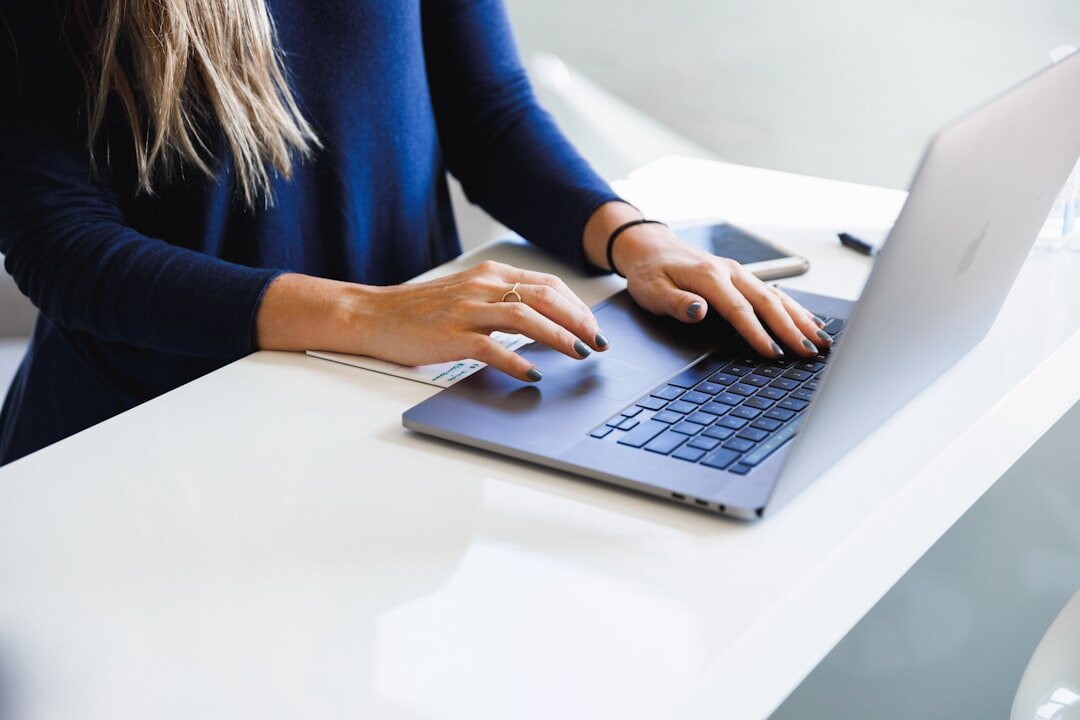 mystery writer typing on laptop